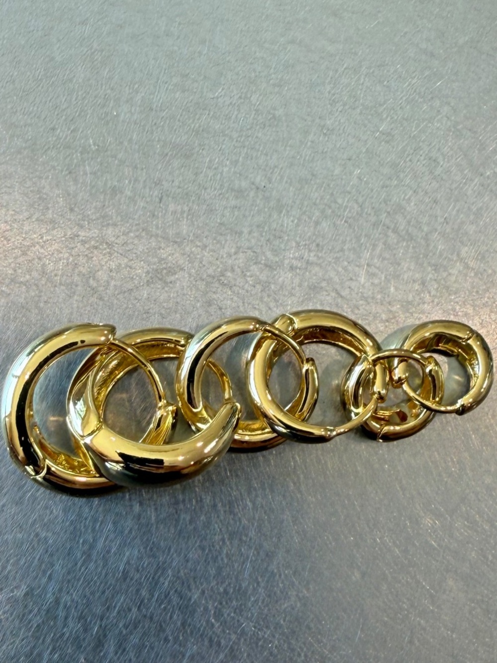 Three pairs of gold hoop earrings